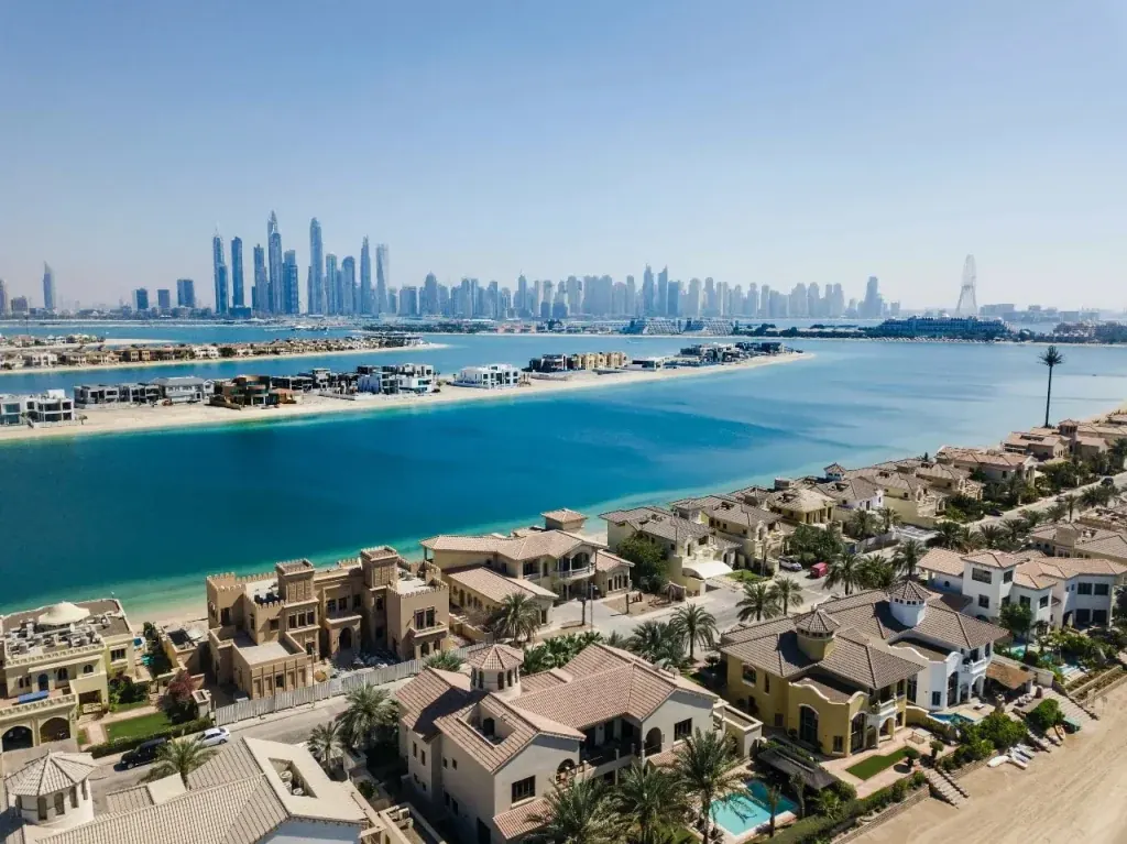 Palm Jumeirah villas with the Dubai Marina skyline across the water